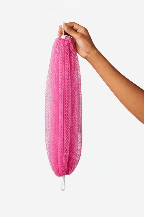 Pink African net bath sponge held by hand
